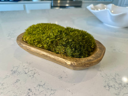 Hand-carved wooden moss bowl filled with dark green preserved pillow moss.